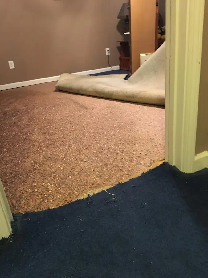 Carpet pad removal revealing water damage during Drying & Dehumidification in Hightstown